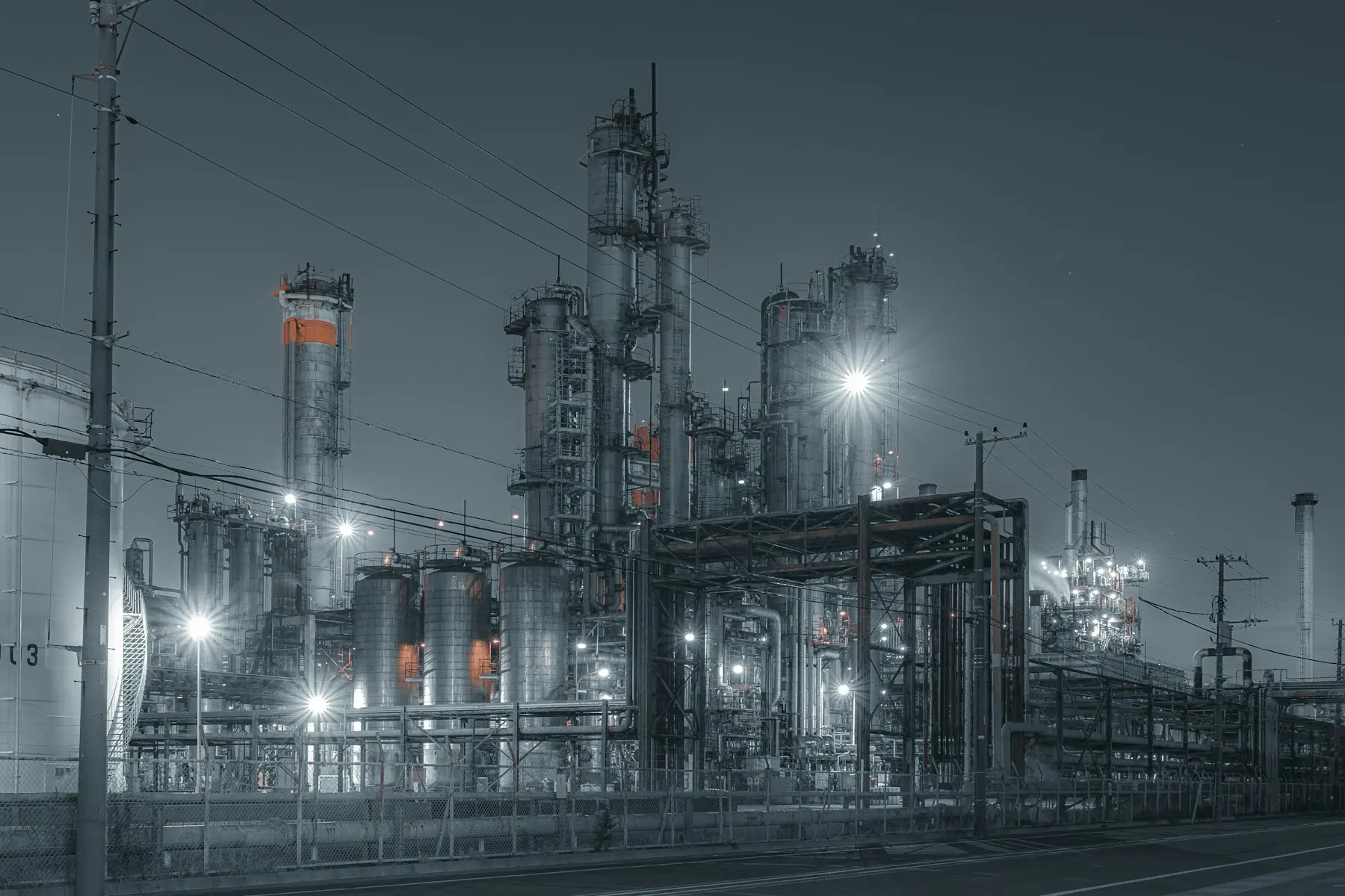Chemical process plant with distillation towers and pipe racks lit at night