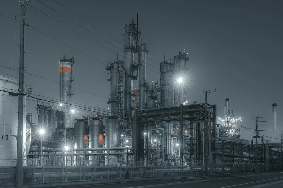 Chemical process plant with distillation towers lit at night