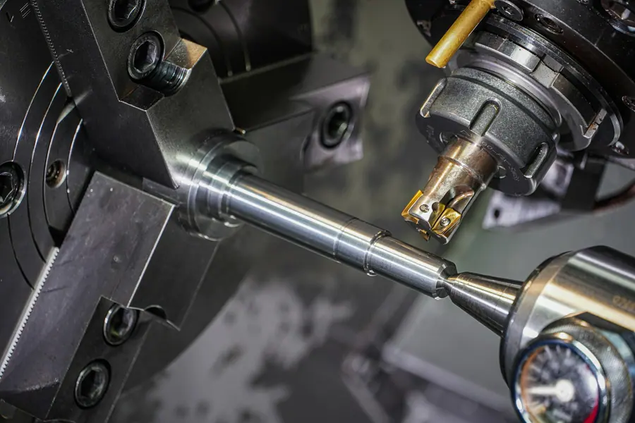 Precision lathe machining a polished metal shaft